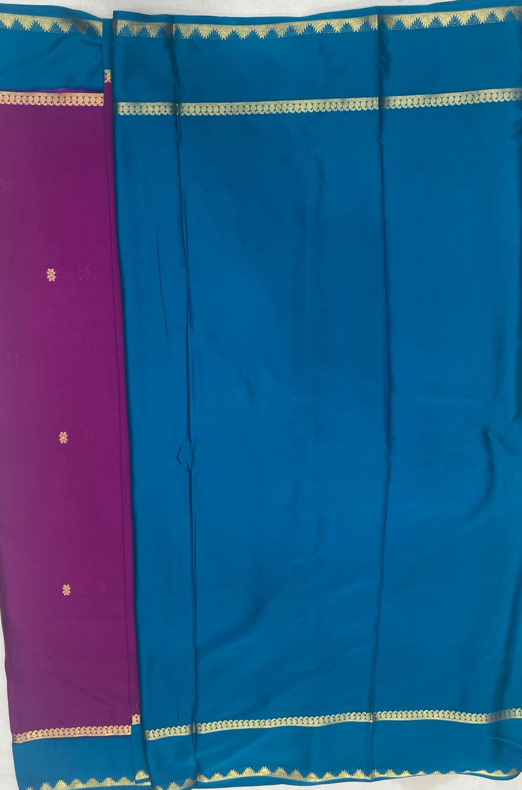 Graceful Rani pink Crape Saree with Blue border.