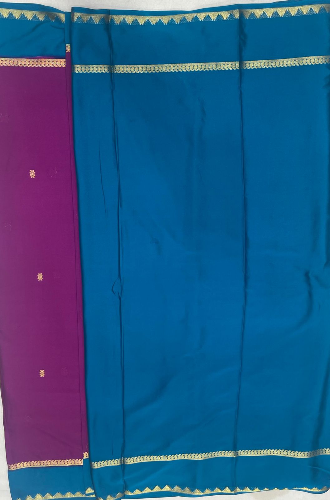Graceful Rani pink Crape Saree with Blue border.
