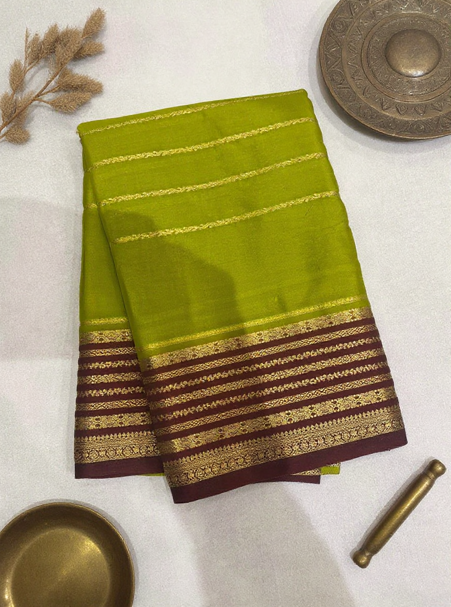 Silk Studio Parrot Green Crape Saree with Brown Contrast Border.